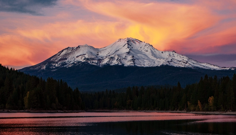 Woman energetically hiking Mt. Shasta, radiating stamina
